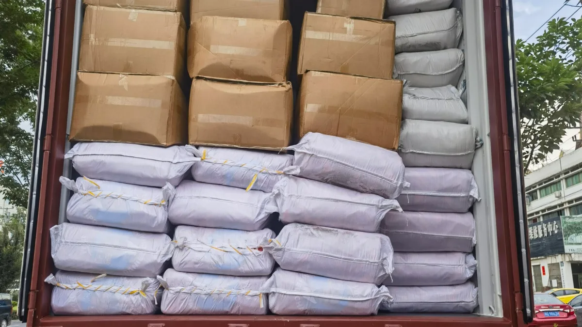 Cartons and bagged goods loaded in a container on a truck