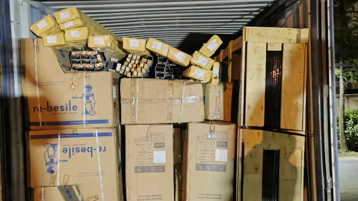 Cartons and wooden crates loaded in a container on a truck