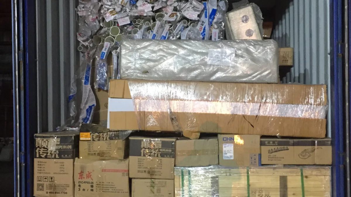 Consolidated container with cartons, bagged goods and a wrapped pallet