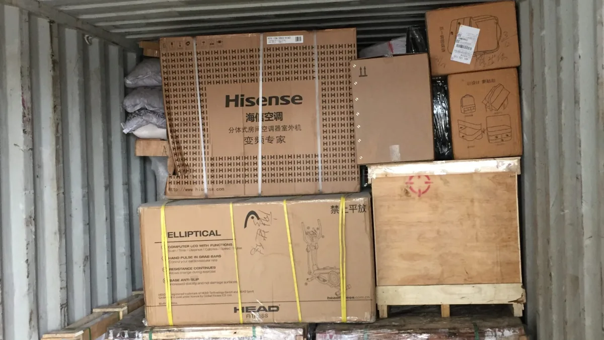 Home appliance cartons and wrapped pallets loaded in a container