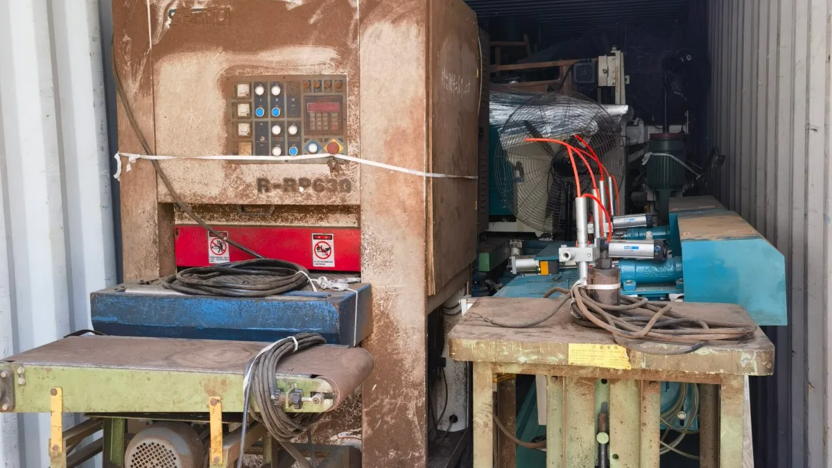 Industrial machines and workbenches loaded in a container