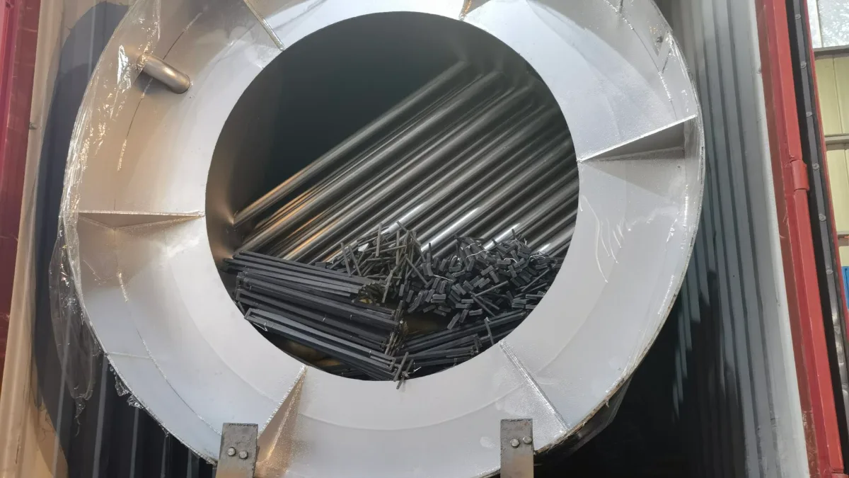 Large steel fan housing with pipes nested inside to save container space
