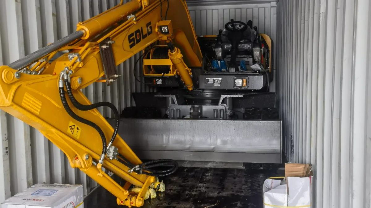 Mini excavator loaded inside a shipping container
