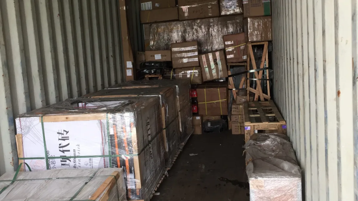 Palletized building materials and cartons inside a 40ft container