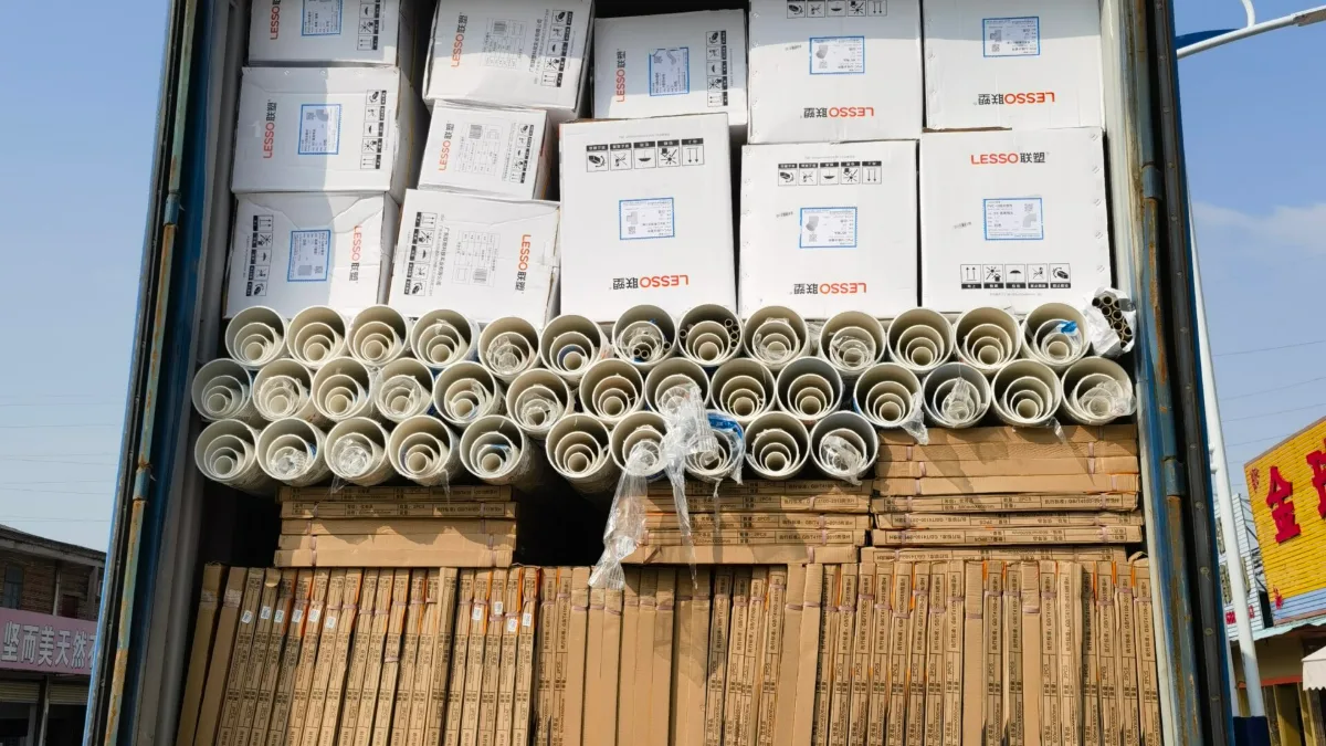 PVC pipes and cartons loaded in a container on a truck