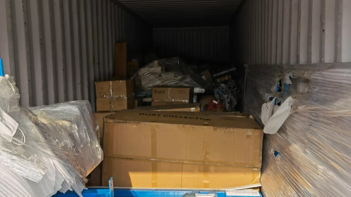 Steel frame, cartons and wrapped parts in a container