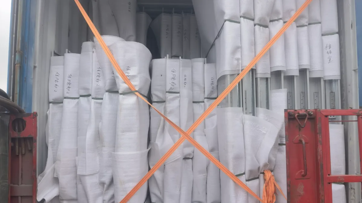 Wrapped goods secured with lashing straps in a container